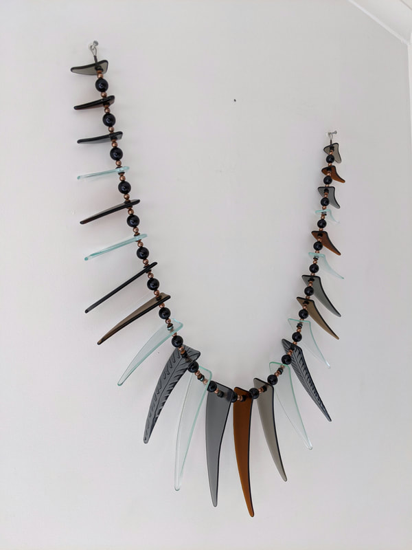Jenny McLeod- "Bronze, Grey and Clear Tusk Wall Necklace", Glass and Resin Beads, 700mm width, 2021, SOLD